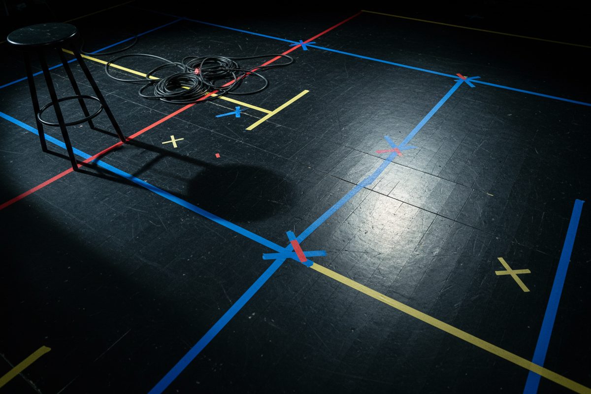 Stage floor with chalked rehearsal marks and stage cabling